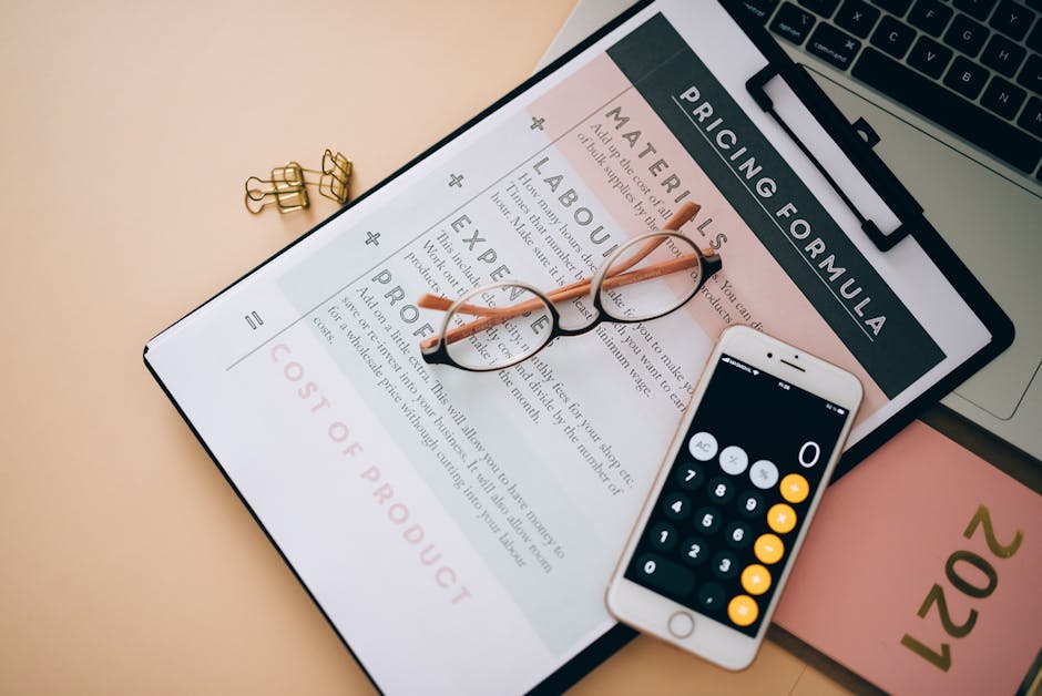 A digital pricing form displayed on a clipboard, labeled 'Pricing Formula' with sections for materials, labours, expertise, and profits, is centered on a light-colored desk. Resting on the form are a 
